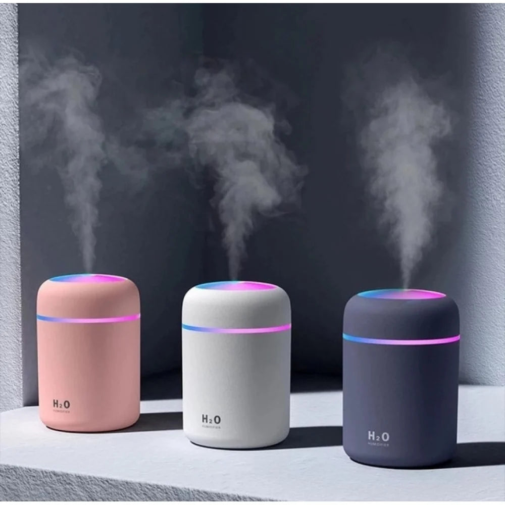 Three mini cool-mist humidifiers in pink, white and grey